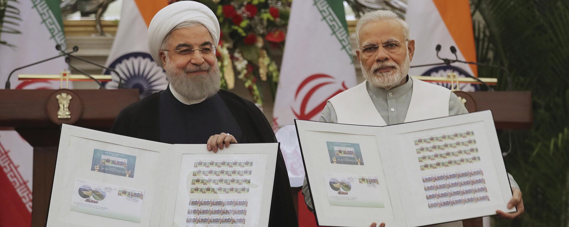 Indian Prime Minister Narendra Modi, right, with Iranian President Hassan Rouhani release a postal stamp commemorating growing economic and trade ties between the two nations in New Delhi, India, Saturday, Feb. 17, 2018 - Sputnik International, 1920, 15.05.2024