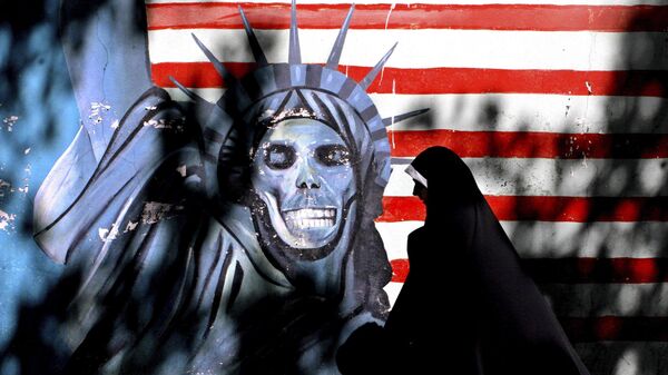 In this Sept. 25, 2007, file photo, an Iranian woman walks past graffiti art characterizing the U.S. Statue of Liberty, painted on the wall of the former U.S. Embassy in Tehran, Iran - Sputnik International