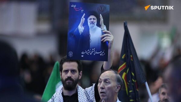 An Iranian man attends a farewell ceremony for Ebrahim Raisi in Tehran. - Sputnik International