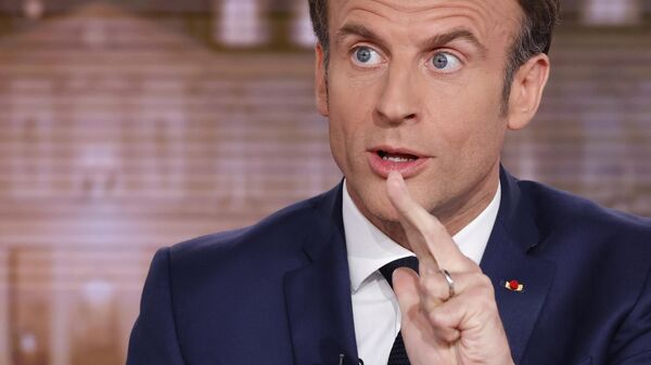French President and centrist candidate for reelection Emmanuel Macron gestures during the evening news broadcast of French TV channel TF1, in Boulogne-Billancourt, outside Paris, Wednesday, April 13, 2022 - Sputnik International