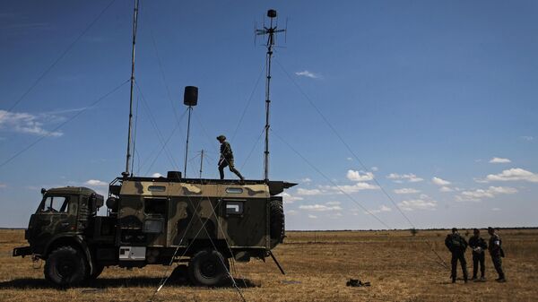 Servicepersons by the Zhitel jamming communication station during the district stage of the field training competition held among units of electronic warfare of the Southern Military District at Nikolo-Aleksandrovsky training range, Stavropol Territory - Sputnik International