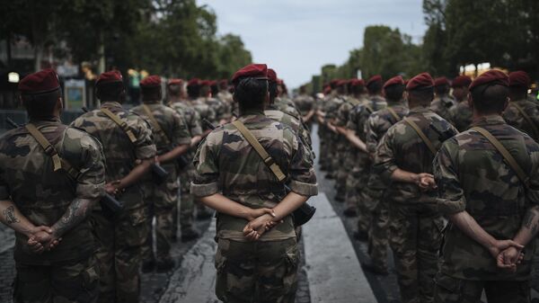 Soldiers wait on the Champs Elysees avenue during a rehearsal for the Bastille Day parade in Paris Monday, July 12, 2021 - Sputnik International