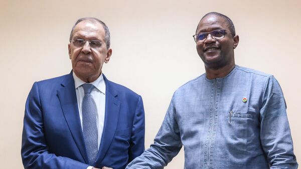In this handout photo released by the Russian Foreign Ministry, Russian Foreign Minister Sergey Lavrov shakes hands with Foreign Minister of Burkina Faso Karamoko Jean Marie Traore during a meeting in Ouagadougou - Sputnik International
