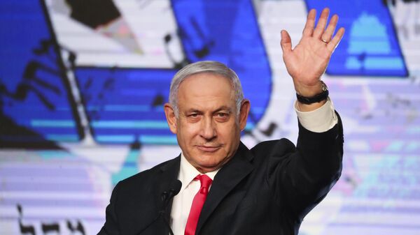 Israeli Prime Minister Benjamin Netanyahu waves to his supporters after the first exit poll results for the Israeli parliamentary elections at his Likud party's headquarters in Jerusalem, Wednesday, March. 24, 2021 - Sputnik International