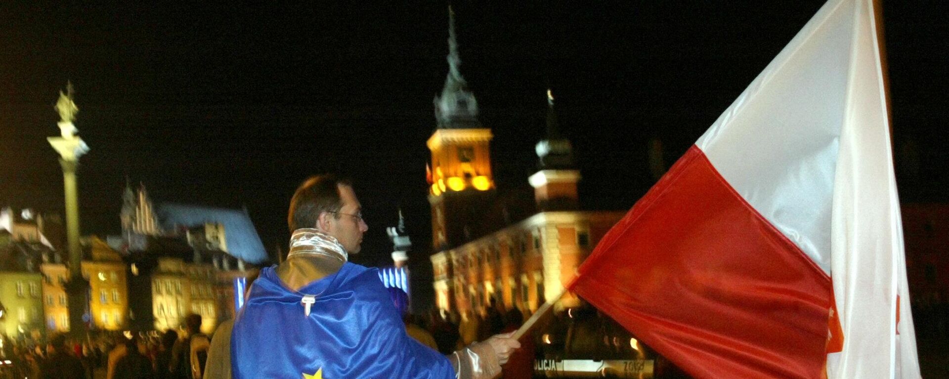 A man covered with the EU flag and waving the Polish national flag walks down the street of the Old Town in Warsaw. File photo - Sputnik International, 1920, 11.06.2024