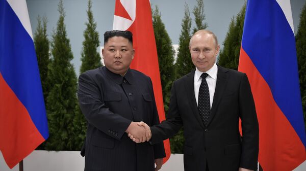 Russian President Vladimir Putin and North Korean leader Kim Jong Un shake hands during their meeting at the Far Eastern Federal University campus on Russky Island in Vladivostok, Russia. - Sputnik International