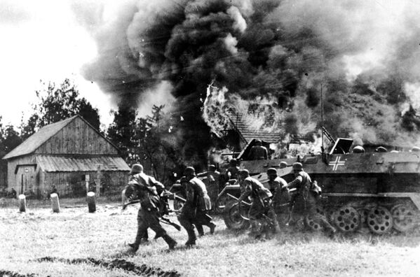 The Nazi invasion was preceded by an extensive disinformation campaign conducted by Berlin, which afforded the Third Reich the element of surprise.Above: Nazi German soldiers, supported by armored personnel carriers, move into a burning Russian village, somewhere along the German-Russian front, in this June 26, 1941, file photo. - Sputnik International