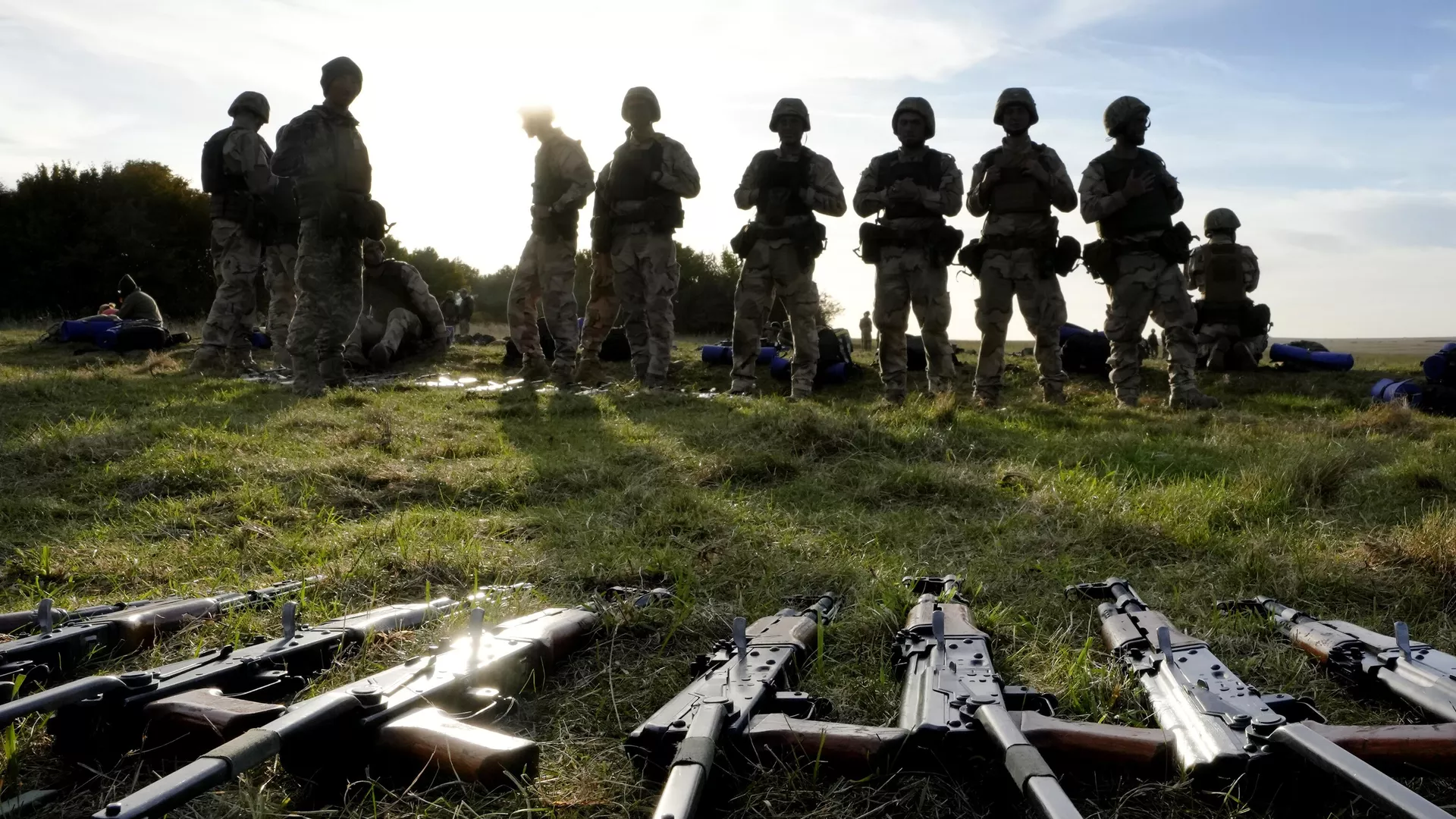 Weapons lie on the ground as Ukrainian personnel take a break during training  - Sputnik International, 1920, 22.06.2024