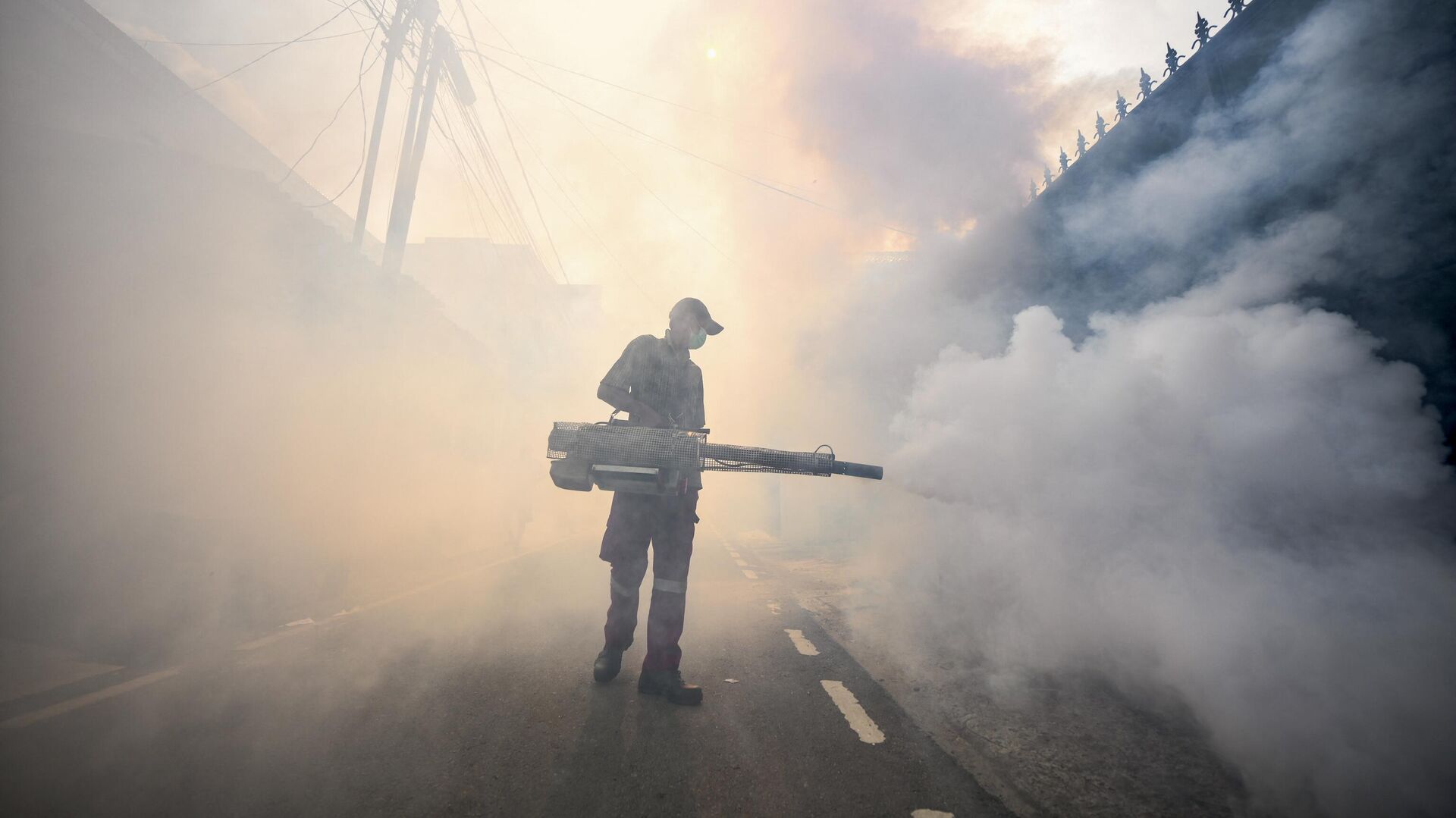 A pest control officer fumigates a street with insecticides in Jakarta on May 8, 2024 amid efforts to stop the spread of dengue fever mosquitoes - Sputnik International, 1920, 07.07.2024