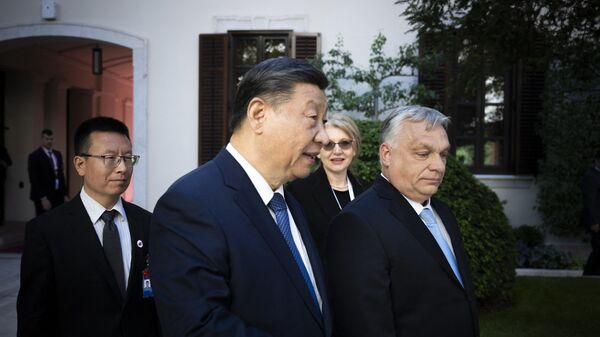 Chinese President Xi Jinping (L2) talks with Hungarian Prime Minister Viktor Orban (R) prior to their official talks in Carmelita Monastery, the prime minister's headquarter, at Buda Castle quarter in Budapest, Hungary on May 9, 2024 - Sputnik International