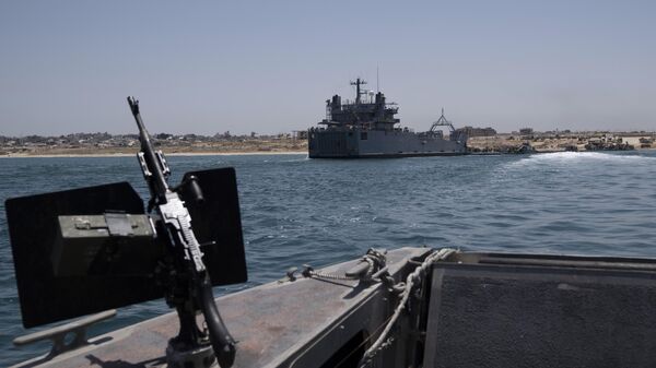 A U.S. Army vessel is seen moored at the U.S.-built floating pier Trident that connects to the beach on the coast of the Gaza Strip, Tuesday, June 25, 2024.  - Sputnik International