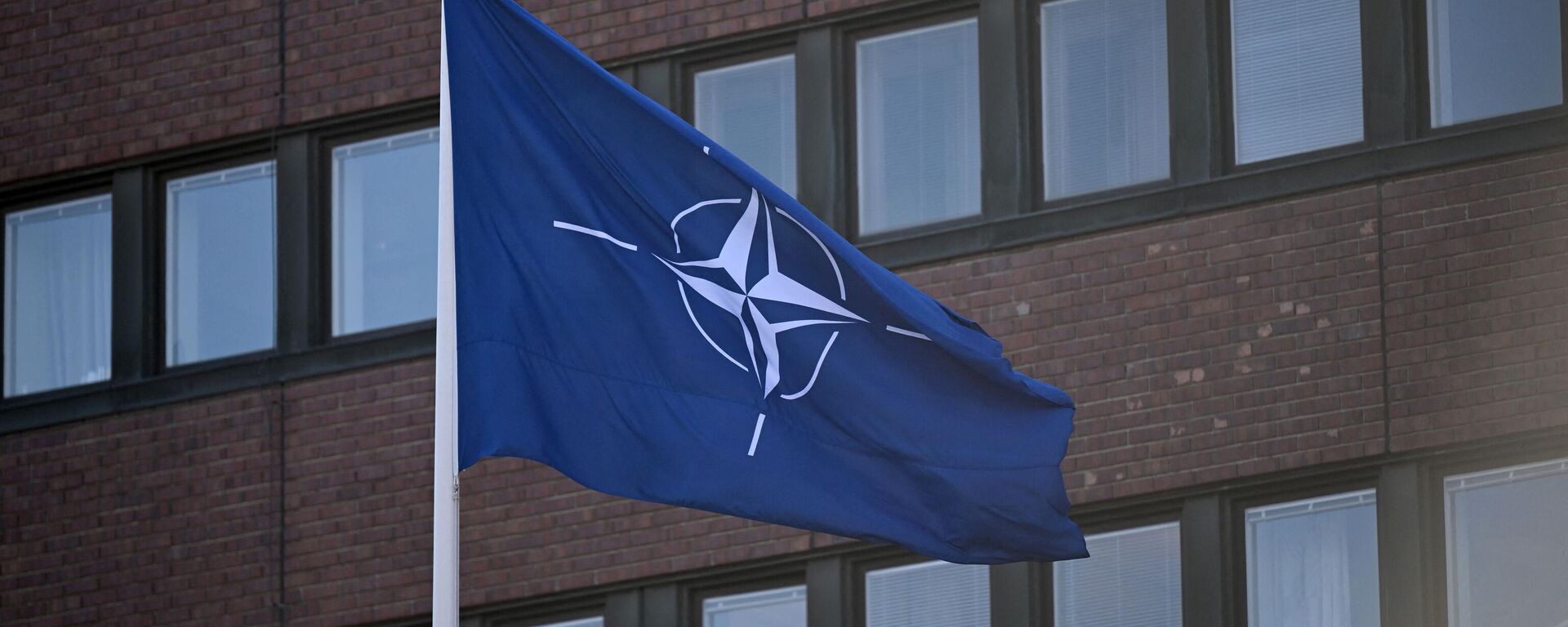 The NATO flag flutters in the wins after it was hoisted in front of the headquarters of Sweden's Armed Forces in Stockholm on March 11, 2024, to mark the entry of Sweden in the alliance. - Sputnik International, 1920, 17.07.2024