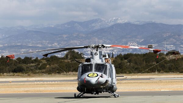 A Griffin HAR2 helicopter from the RAF Akrotiri multi-role 84 Squadron sits on the tarmac during a parade marking the centenary of the 84 Squadron at the Sovereign Base Area (SBA) of Akrotiri, a British overseas territory located ten kilometres west of the Cypriot port city of Limassol, on February 16, 2017. - Sputnik International