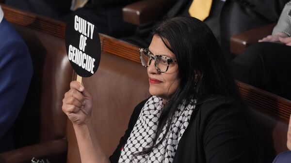 Rep. Rashida Tlaib, D-Mich., holds a sign as she attends a speech by Israeli Prime Minister Benjamin Netanyahu to a joint meeting of Congress at the Capitol in Washington, Wednesday, July 24, 2024. (AP Photo/J. Scott Applewhite) - Sputnik International