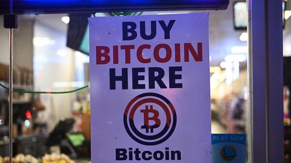 A sign offering Bitcoin for sale is seen in a store window in Hollywood, California, October 20, 2022.  - Sputnik International