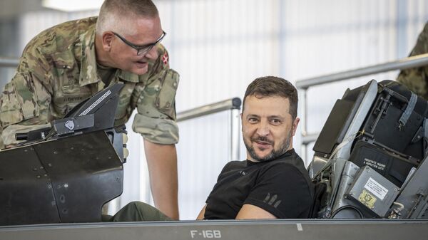 Volodymyr Zelensky sits in a F-16 fighter jet in the hangar of the Skrydstrup Airbase in Vojens, northern Denmark, - Sputnik International