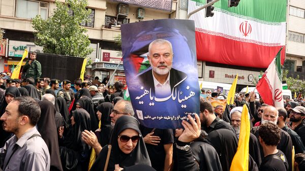 Iranians hold portraits of late Hamas leader Ismail Haniyeh during his funeral procession, in Tehran, on August 1, 2024, ahead of his burial in Qatar.  - Sputnik International