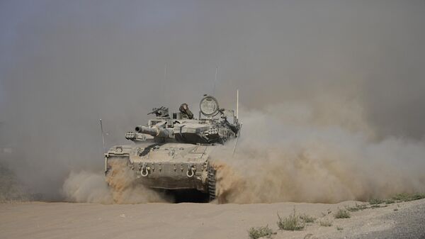 An Israeli tank maneuvers near the Israel-Gaza border in southern Israel, Friday, July 12, 2024.  - Sputnik International