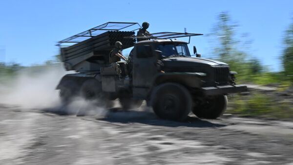 Russian servicemen of the Central Military District ride a BM-21 Grad multiple rocket launcher to a position amid Russia's military operation in Ukraine - Sputnik International