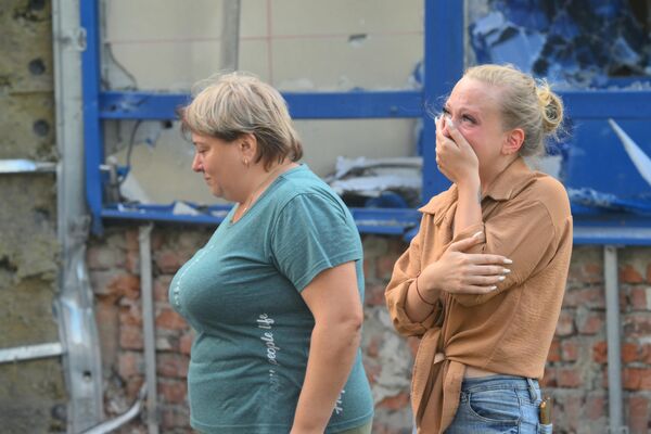 A young woman reacts as she sees the consequences of the Ukrainian shelling of Kursk. - Sputnik International