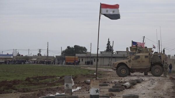 In this frame grab from video, an American military convoy is seen in the village of Khirbet Ammu, east of Qamishli city, Syria, Wednesday, Feb. 12, 2020. - Sputnik International