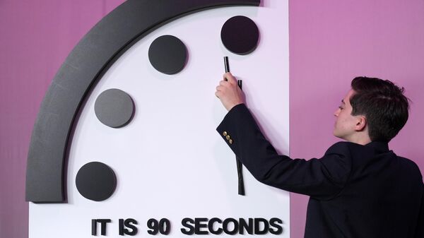 A staffer shows the location of the minute hand shortly before the Bulletin of the Atomic Scientists announces the latest decision on the Doomsday Clock minute hand, Tuesday, Jan. 23, 2024, at the National Press Club Broadcast Center, in Washington - Sputnik International