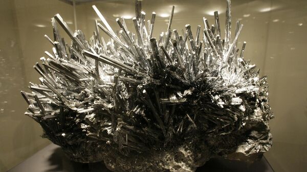 A stibnite specimen is on display at the American Museum of Natural History in New York. The 1,000 pound stibnite with hundreds of sword-like, metallic blue-gray crystals sprouting from a rocky base,  was discovered in an antimony mine in Jiangxi Province of southeastern China. It is the largest stibnite specimen on public display in the world, and was likely formed some 130 million years ago. Stibnite, also known as antimonite, is a sulfide metalloid mineral of antimony. - Sputnik International