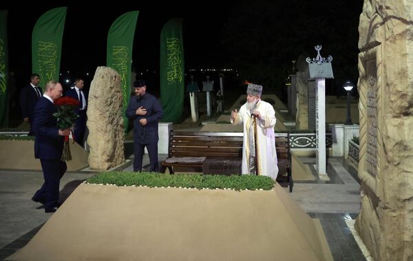 Vladimir Putin and Akhmat Kadyrov&#x27;s cousin, Chairman of the North Caucasus Federal District Alim Council Khozh Akhmat Kadyrov at the tomb of Akhmat Khadzhi Kadyrov, Chechnya’s first president and hero of Russia, in the village of Akhmat-Yurt. - Sputnik International