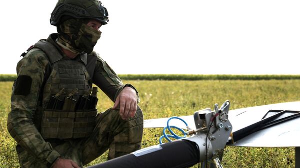 A Russian serviceman of the 116th separate special purpose brigade of the Russian National Guard prepares to launch an unmanned aerial vehicle - Sputnik International