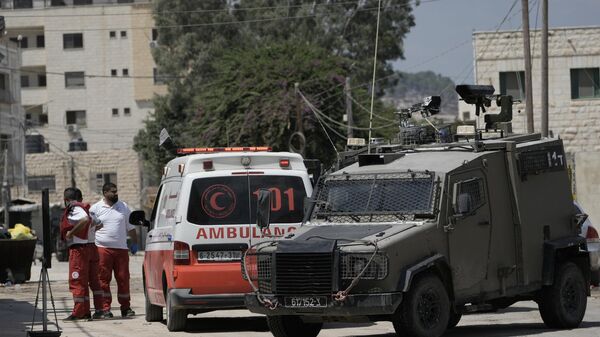 Members of the Israeli forces inside an armoured vehicle check an ambulance during a military operation in the West Bank city of Jenin, Wednesday, Aug. 28, 2024. (AP Photo/Majdi Mohammed) - Sputnik International