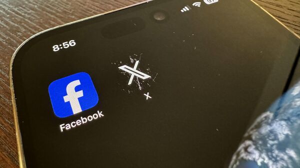 App logos for Facebook, left, and X, formerly known as Twitter, are seen on a mobile phone in Los Angeles, Saturday, March 16, 2024 - Sputnik International