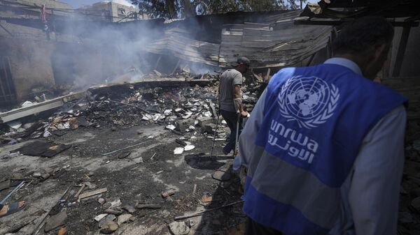 Palestinians look at the destruction after an Israeli strike on a school run by UNRWA, the U.N. agency helping Palestinian refugees, in Nuseirat, Gaza Strip, May 14, 2024. Qatar and Saudi Arabia on Sunday, June 2, 2024 condemned an Israeli parliamentary bill that seeks to label UNRWA, the main provider of aid for Palestinians in Gaza, a terrorist group, joining a growing number of nations opposed to the proposal - Sputnik International