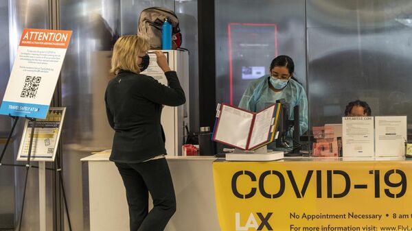 Traveler Patty Siegel from Los Angeles gets tested for COVID-19 before a planned trip to Hawaii at the Los Angeles International Airport in Los Angeles Wednesday, Nov. 25, 2020 - Sputnik International