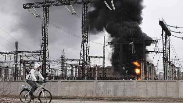 A man cycles past an electricity facility after a Russian attack in Kharkov, Friday March 22, 2024. - Sputnik International