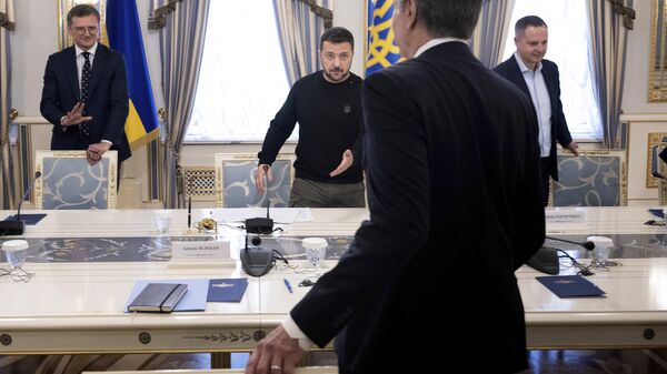 Ukraine's President Volodymyr Zelensky, center, Ukraine's Foreign Minister Dmytro Kuleba, left, and US Secretary of State Antony Blinken take their seats prior to their talks in Kiev, Ukraine, Tuesday, May 14, 2024.  - Sputnik International