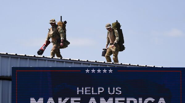 Security gets in position prior to Republican presidential nominee former President Donald Trump speaks at a rally, Wednesday, Aug. 21, 2024, in Asheboro, N.C. Wednesday's event is the first outdoor rally Trump has held since the attempted assassination of the former president - Sputnik International