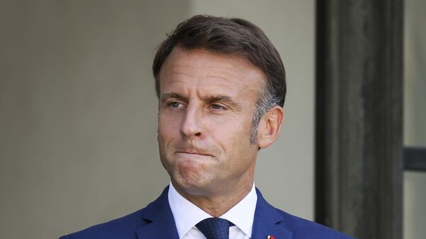 French President Emmanuel Macron gestures at the Elysee Palace as French left-wing coalition accuses Emmanuel Macron of denying democracy after he has rejected the New Popular Front's candidate to form a new government following last month's inconclusive election, Tuesday, Aug. 27, 2024 in Paris. - Sputnik International