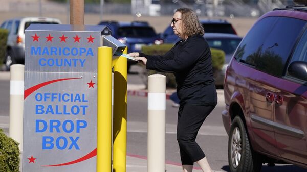 A voter places a ballot in an election voting drop box in Mesa, Ariz., Oct. 28, 2022.  - Sputnik International