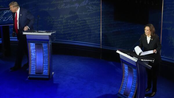 Republican presidential nominee former President Donald Trump, left, walking away from his podium at the end of an ABC News presidential debate with Democratic presidential nominee Vice President Kamala Harris, right, at the National Constitution Center, Tuesday, Sept.10, 2024, in Philadelphia.  - Sputnik International