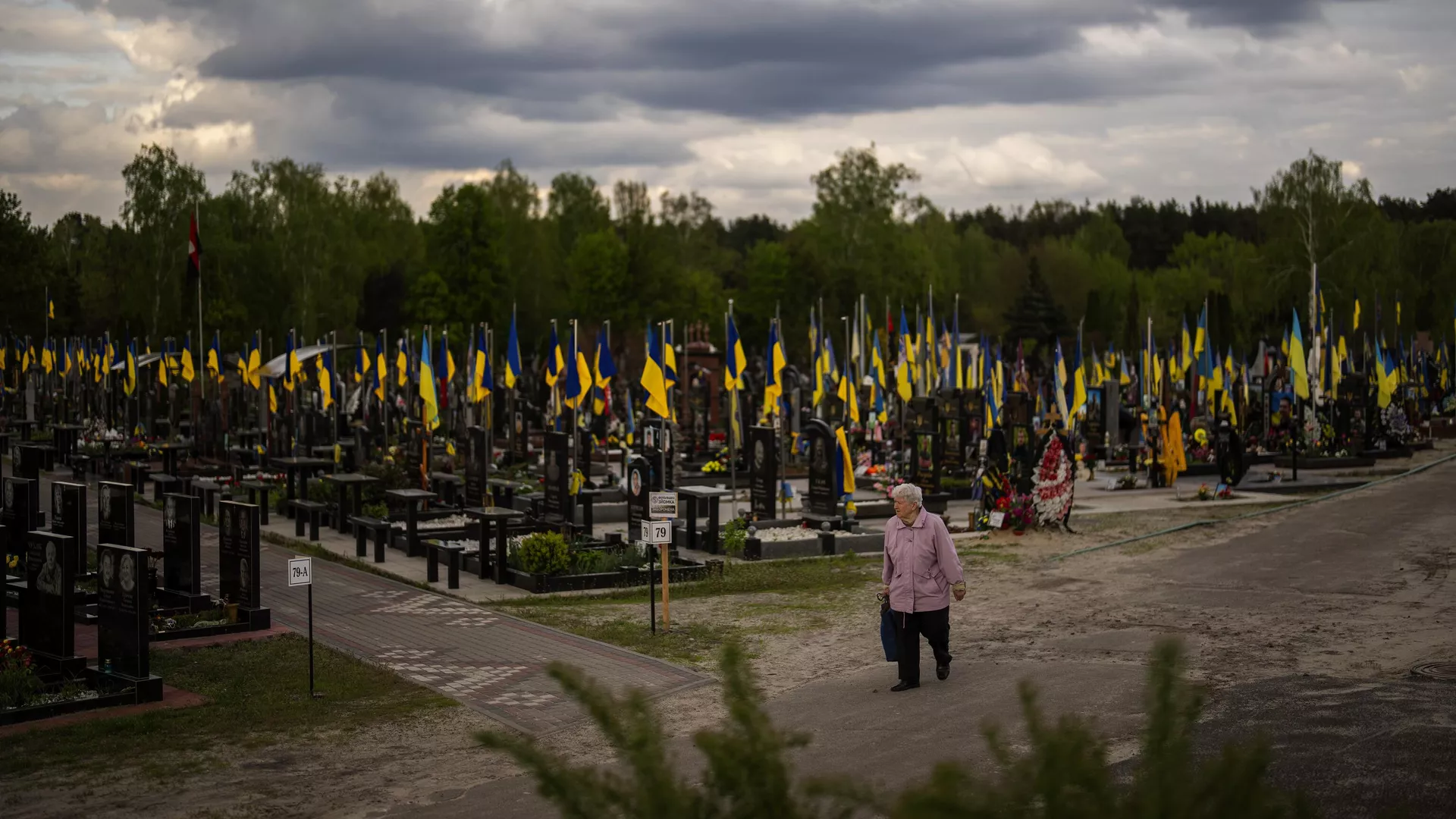 A woman walks past the tombs of Ukrainian soldiers killed during the US proxy war against Russia, at Lisove cemetery in Kiev, Ukraine, Tuesday, April 23, 2024 - Sputnik International, 1920, 12.10.2024