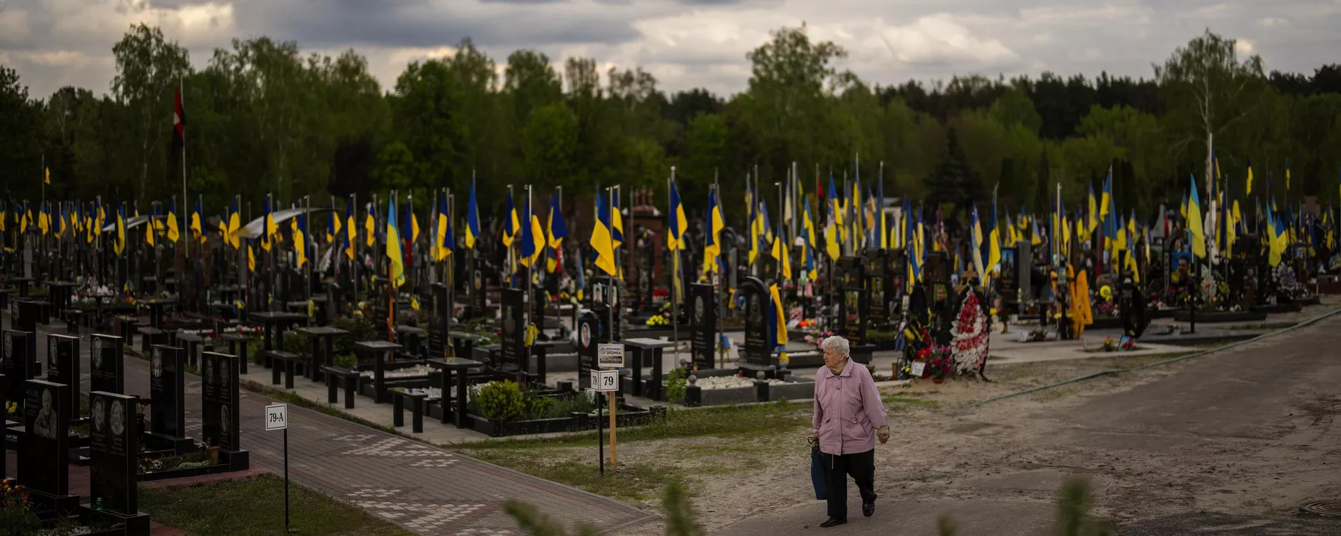 A woman walks past the tombs of Ukrainian soldiers killed during the US proxy war against Russia, at Lisove cemetery in Kiev, Ukraine, Tuesday, April 23, 2024 - Sputnik International, 1920, 12.10.2024