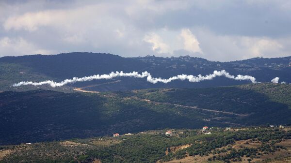 The smoke trail from a Hezbollah rocket, seen from the southern Lebanese town of Marjayoun, Saturday, Sept. 21, 2024. - Sputnik International