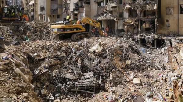 Rescuers sift through the rubble as they search for people still missing at the site of Friday's Israeli strike in Beirut's southern suburbs, Monday, Sept. 23, 2024 - Sputnik International