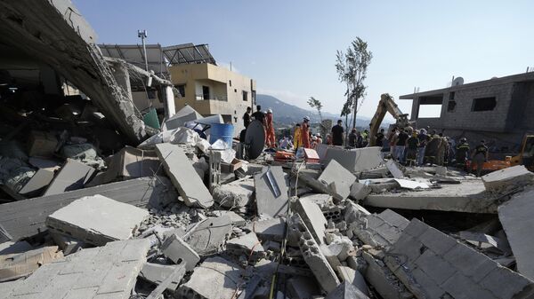 Emergency workers arrive at the scene of an Israeli airstrike in the town of Maisara, north of Beirut, Wednesday, Sept. 25, 2024.  - Sputnik International