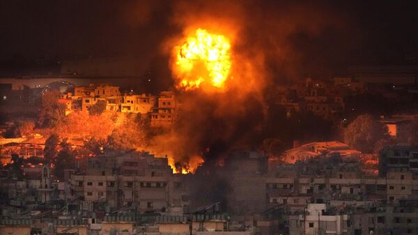 Flames rise after an Israeli airstrike in the southern suburbs of Beirut. - Sputnik International