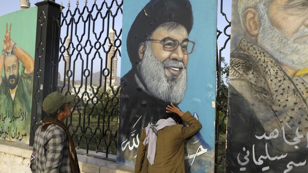 Yemenis stand in front of a portrait of Hezbollah leader Hassan Nasrallah in Sanaa, Yemen - Sputnik International