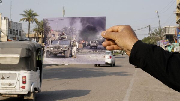 A photograph of U.S. troops securing the area after explosives went off in Baghdad's Palestine Street Wednesday, Dec. 31, 2003, is inserted into the scene at the same location Friday, March 24, 2023. 20 years after the U.S. led invasion on Iraq and subsequent war.  - Sputnik International