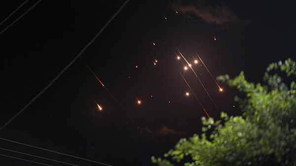 Missiles launched from Iran towards Israel streak across the night sky as seen from Deir al-Balah, Gaza Strip, Tuesday, Oct. 1, 2024 - Sputnik International