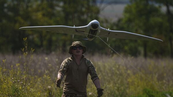 A Ukrainian serviceman of the Ochi reconnaissance unit launches a Furia drone to fly over Russian positions at the frontline in Donetsk region, Ukraine, on Sunday, June 30, 2024.  - Sputnik International