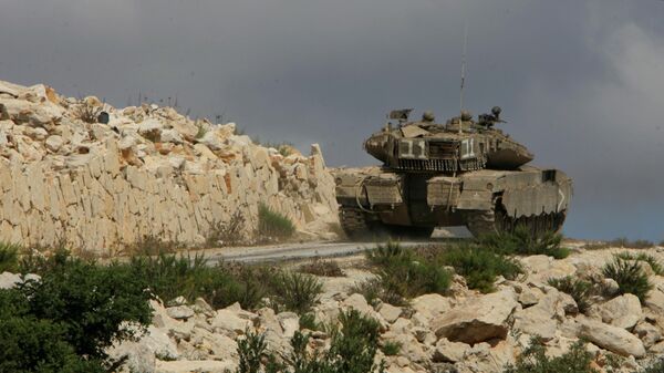 An Israeli Merkava tank drives up a hill to take positions inside Lebanon near the southern city of Marwaheen, Lebanon, - Sputnik International